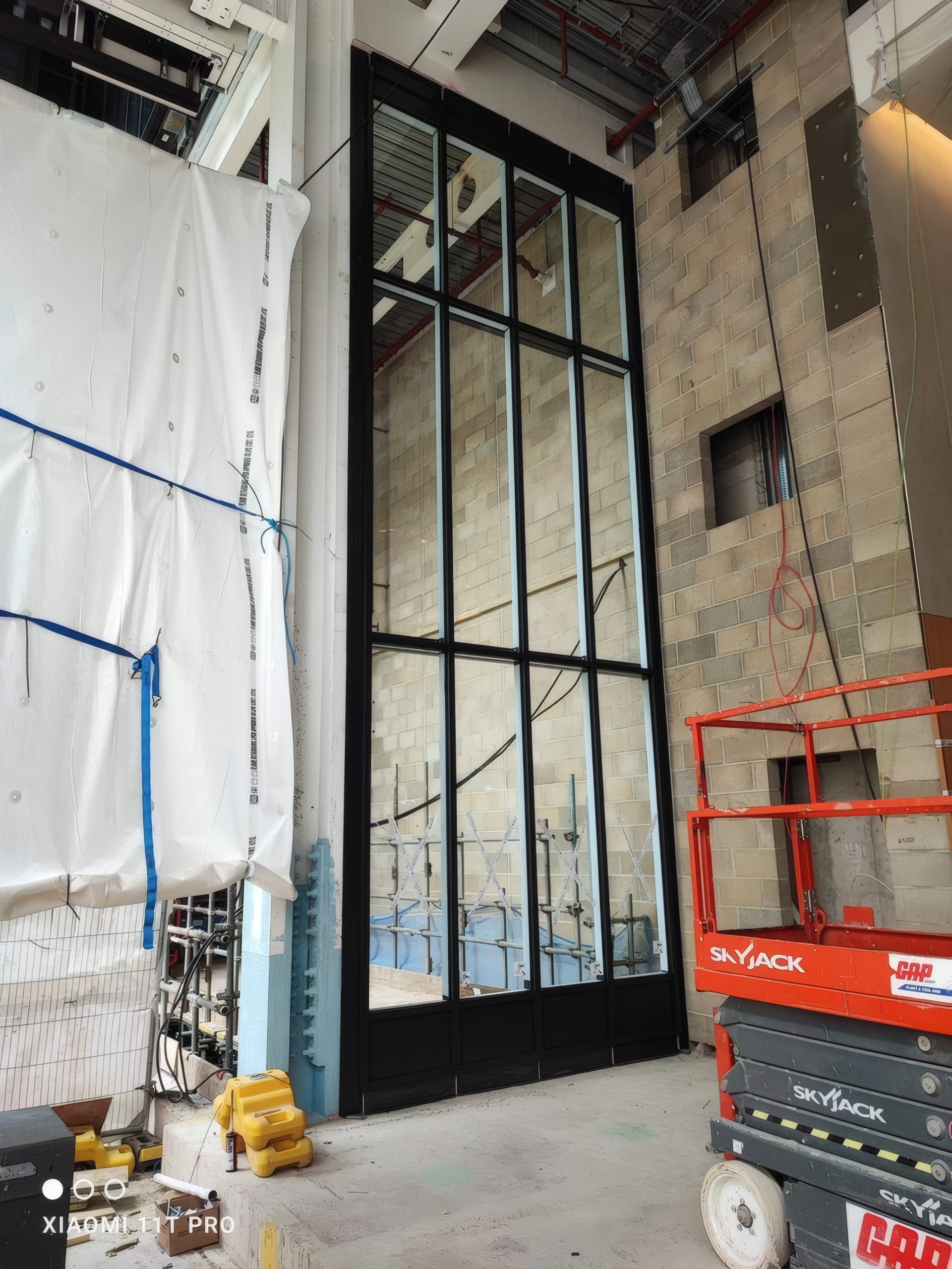 A completed curtain wall corner unit, glazed and weathertight.