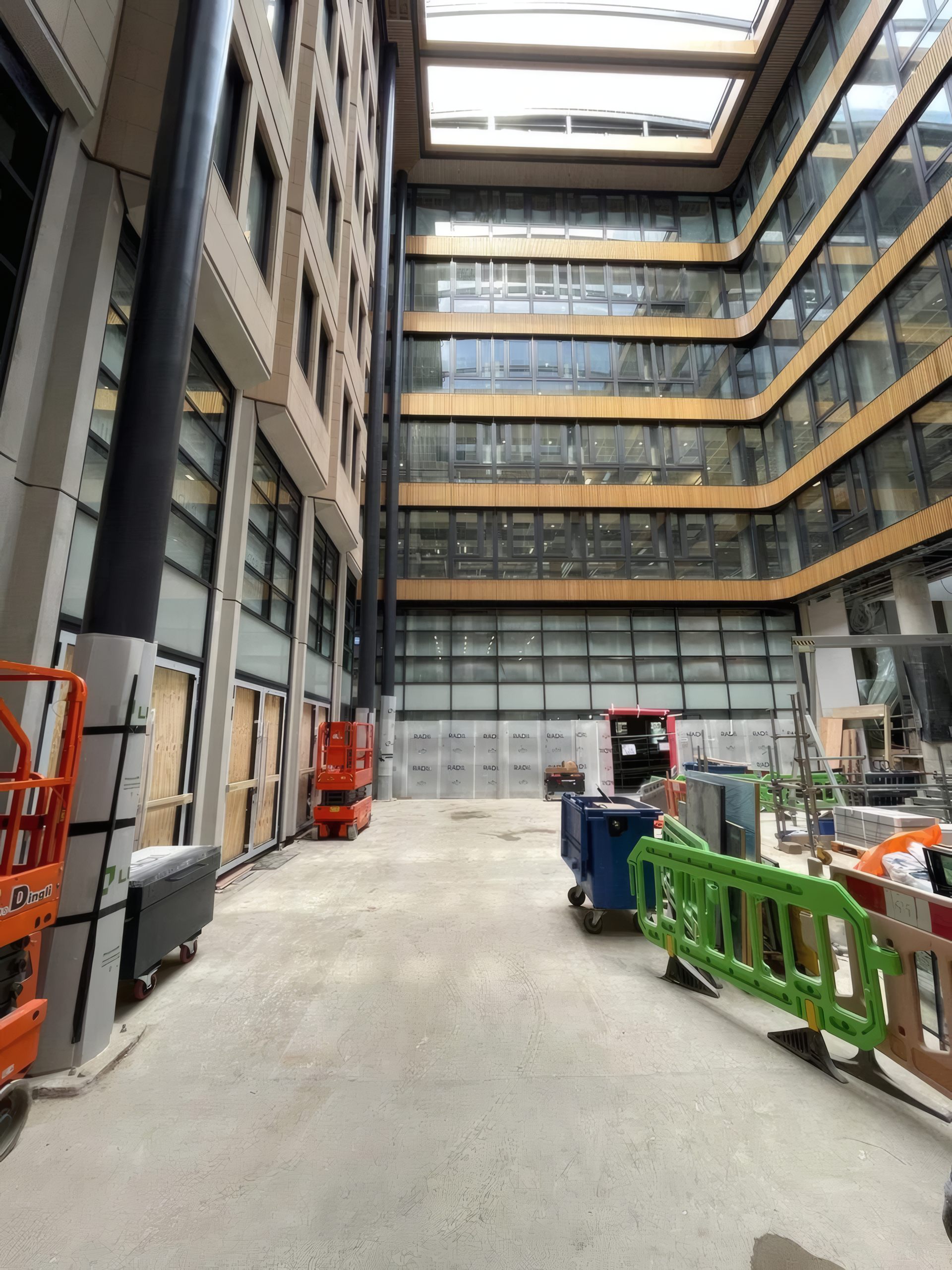 The full-height atrium facade during the later stages of installation.